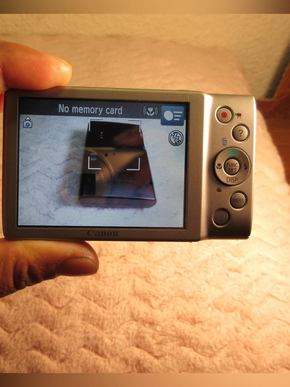 Canon Silver Compact Camera with Black Charger and Accessories